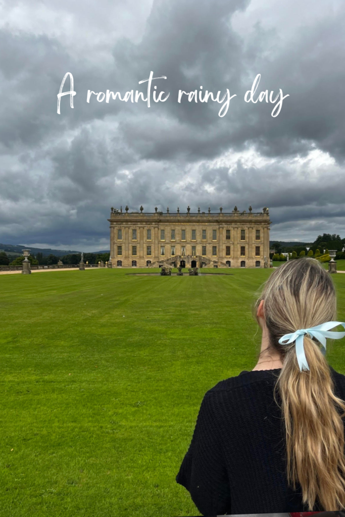 a blonde woman on a grey, rainy day staring at Chatsworth house, the pride and prejudice set