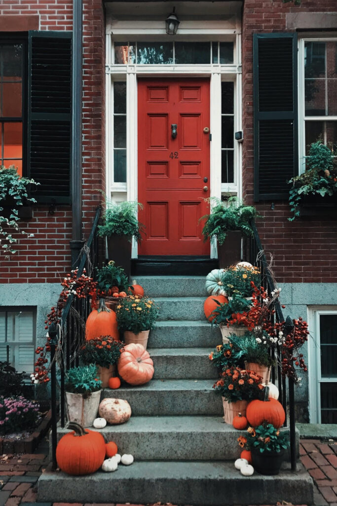 front porch steps decorated with pumpkins for fall 