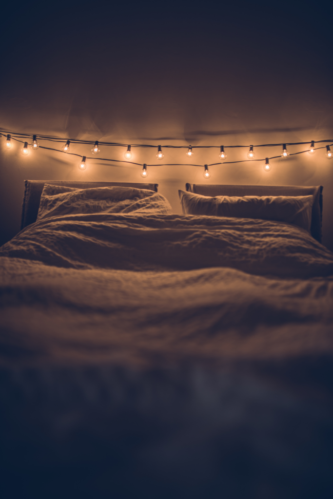 warm string lights above bed 